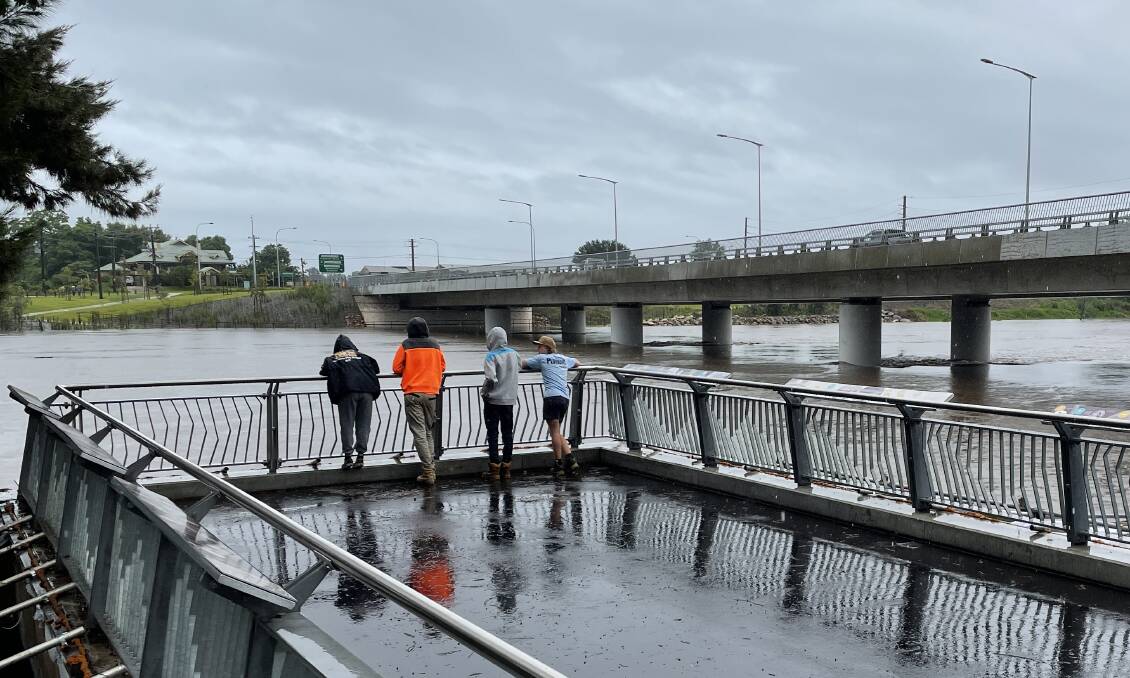 Onlookers watch the rising flood waters at Windsor Bridge during the March 2022 floods. Picture: Sarah Falson