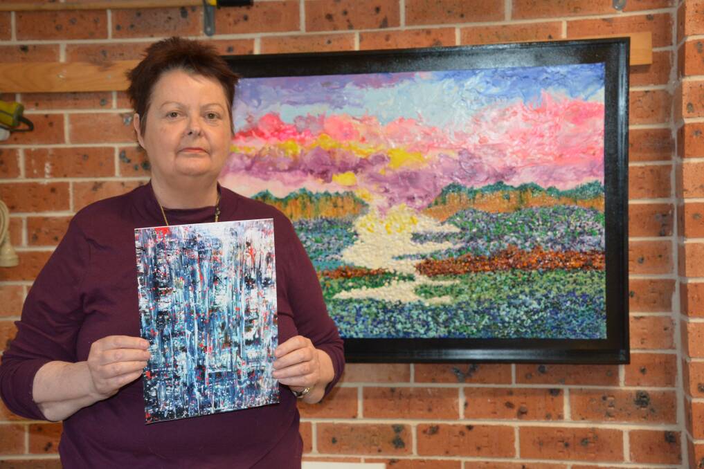 Missing artwork: Trudie Moore holds a print-out of the piece of art she donated to a Sydney charity, which was about the size of the painting behind her.