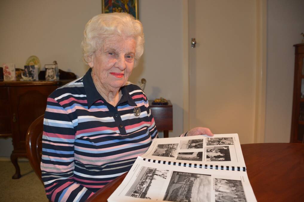 Service to the community: Margaret Allen looks over a booklet she wrote on Winmalee High School's history.