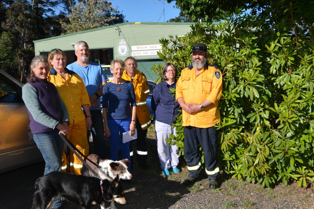 Preferred location for noticeboard: Medlow Bath residents and members of the RFS Catherine Vaubell with Kali and Indra, Diane Gilderdale, Craig Tebbet, Deb Brown, Garry Reid, Darla Taylor and Maurice Bray.