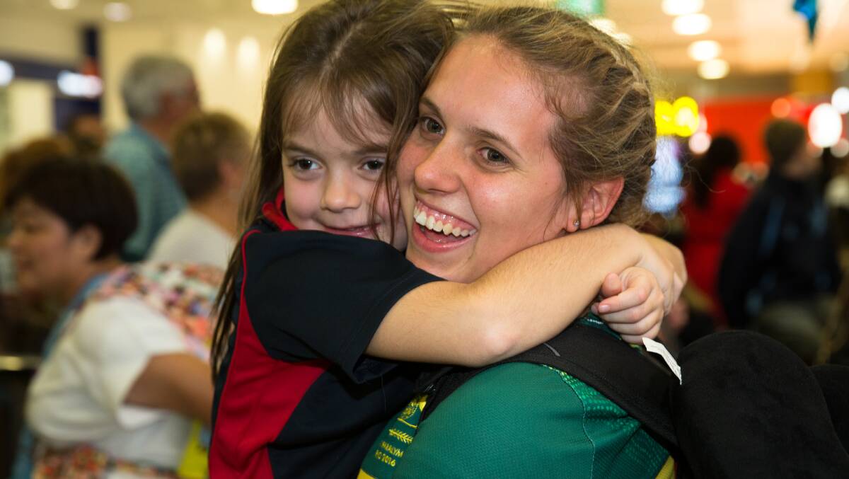 Happy days: Amanda Reid is greeted by her friend's daughter, Aimee Smith, as she arrives back in Sydney from the Rio Paralympics in 2016. Photo: Janie Barrett