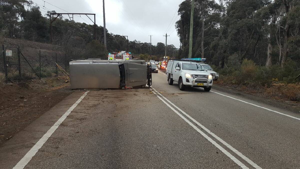 Accident: A vehicle rolled over on the Great Western Highway at Medlow Bath just before 6am on Monday. Photo: Top Notch Video