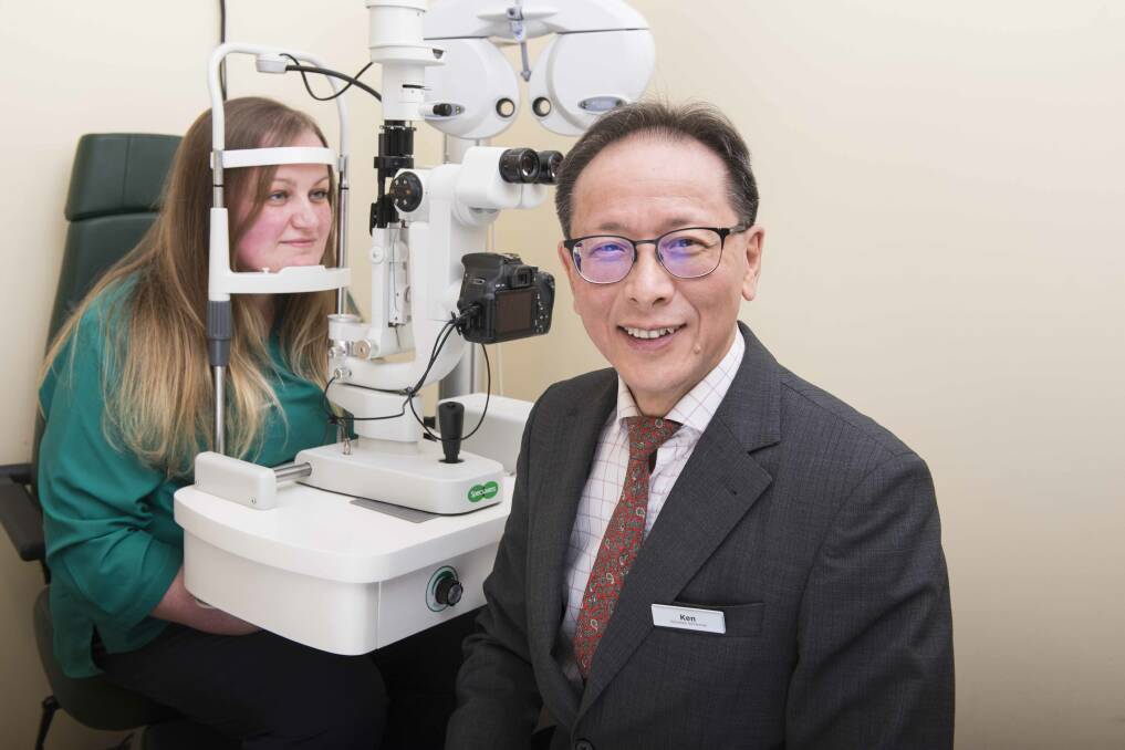 Specsavers Katoomba optometrist Kenneth Poon checks colleague Rachel Boylan's eyes. He says eye checks are important as people have been spending a lot more time in front of screens during the coronavirus pandemic, leading to eye strain.