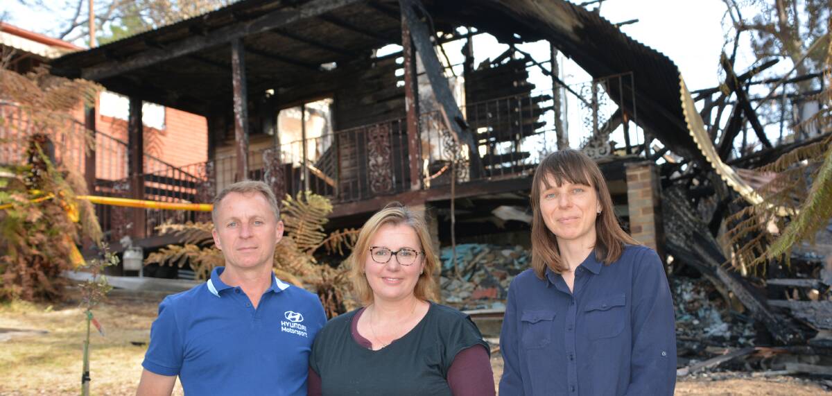 Helping a neighbour in need: Geoff and Debbie Fear and Susannah Sinclair by the charred remains of Mark Bailey's Hazelbrook home.