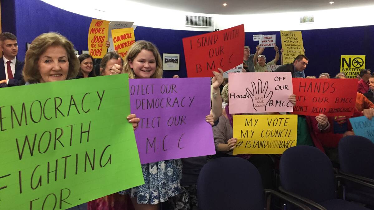 The people for the council: The public gallery was full at Tuesday night's extraordinary council meeting and full of signs in support of, as well as critical of, Blue Mountains Council.