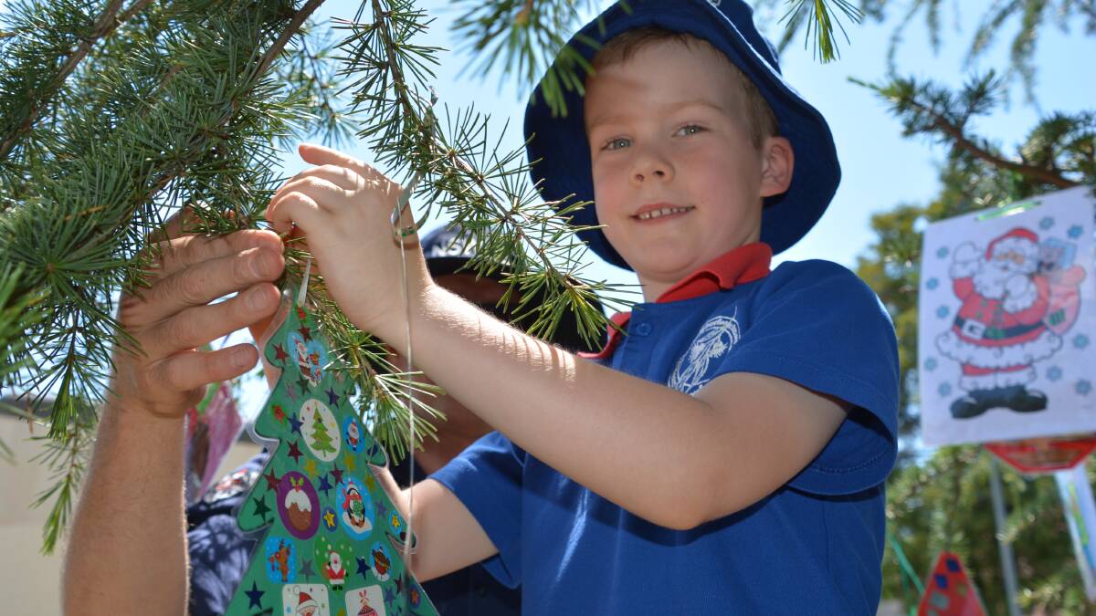 Springwood Public School students from kindergarten to year 2 made Christmas decorations which they hung on the biggest tree in Manners Park in Springwood on Thursday, ably assisted by firefighters from Springwood Fire and Rescue NSW.