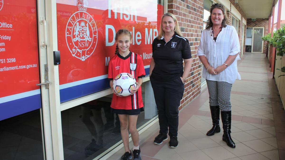 Local sports grant recipients: Springwood United Football Club player Emilie Dempsey and club female participation co-ordinator Rene Dempsey, with Blue Mountains MP Trish Doyle.