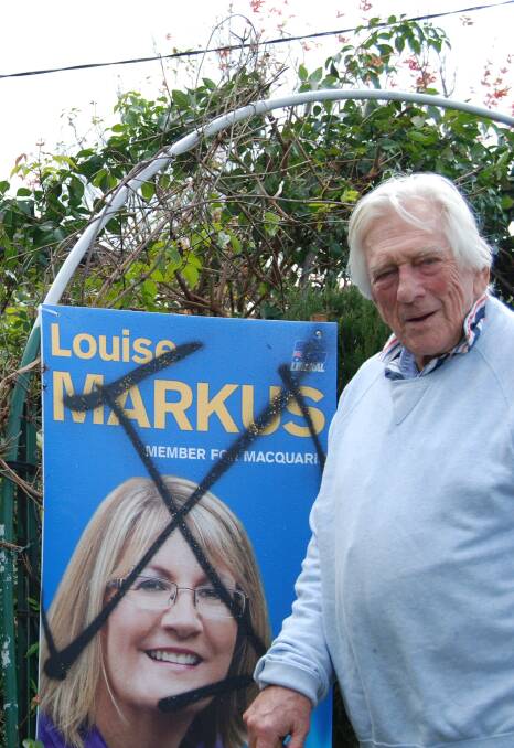 Long-time Liberal: Harry Douglas, with his Louise Markus election sign which has been defaced for the second time this election campaign.