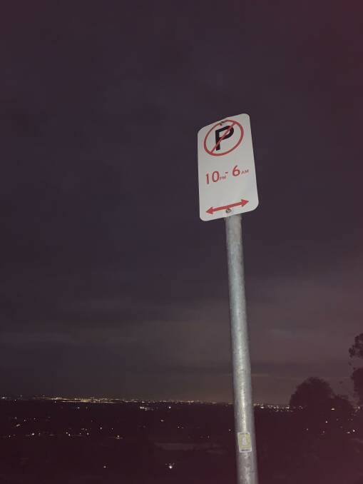 Whether 'No Parking' signs at Hawkesbury Lookout need to be illuminated at night has been questioned after drivers were fined for parking there.