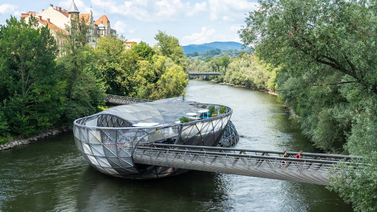 A steel bridge in the Mur River in Graz, Austria, doubles as a cafe and performance space.
