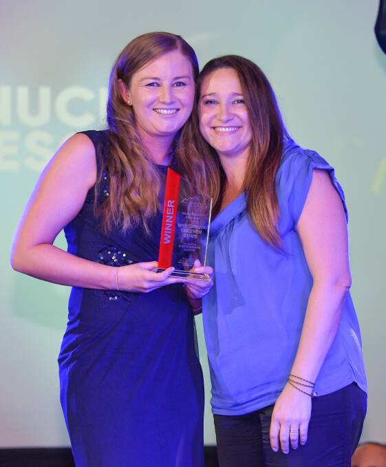 Bree Curnuck, Eagle View Escape receiving her Young Executive Award from Elaine Arriguetti, BM Gazette