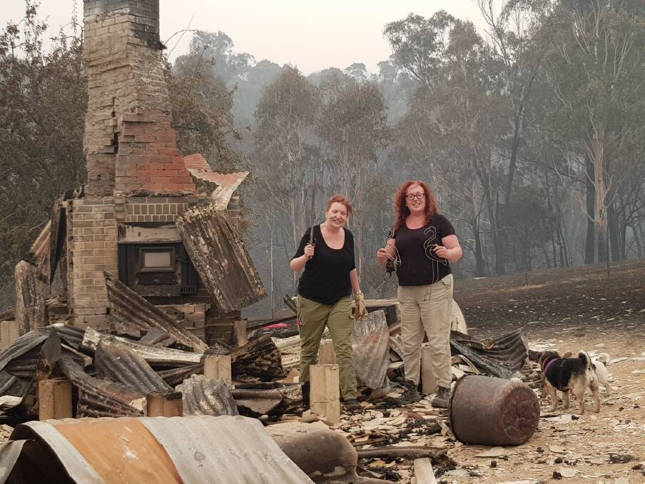 Sisters Gemma and Heidi Pritchard after the New Year's Eve bushfire destroyed their family's property at Tumbarumba.