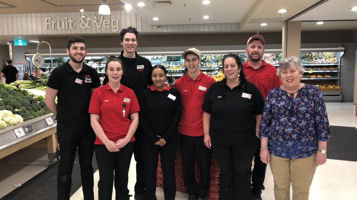 CWA member Robyn Scheinflug at Coles Winmalee with some of the store's staff.