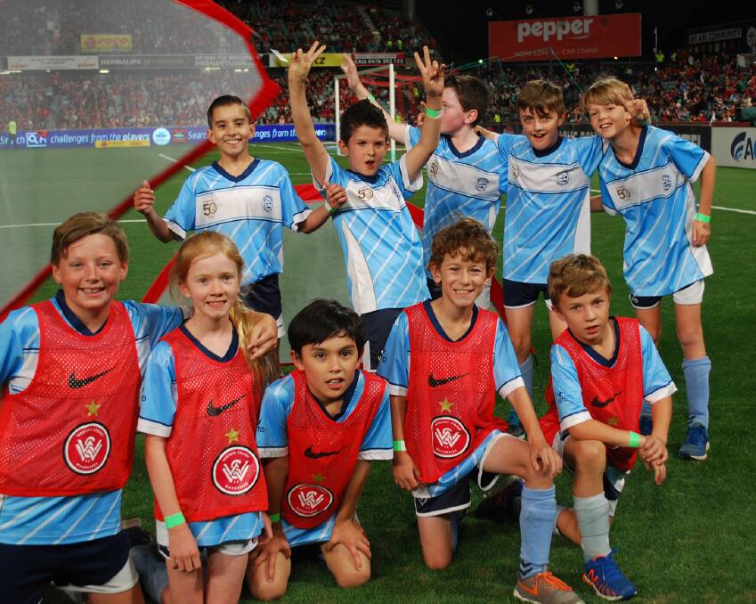 What a thrill: Blue Mountains Football Club U10s yellow team members (wearing bibs) and green team players on the Parramatta Stadium pitch.