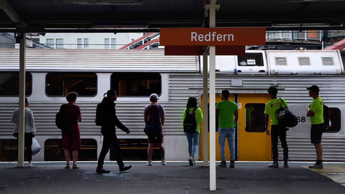 Commuters wait for a train at Redfern station in Sydney. Redfern has been returned as a stop on six peak services on the Blue Mountains LIne. Photo: Kate Geraghty.