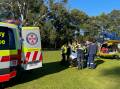 Paramedics help treat a woman in her 80s at Springwood on May 29. Picture CareFlight