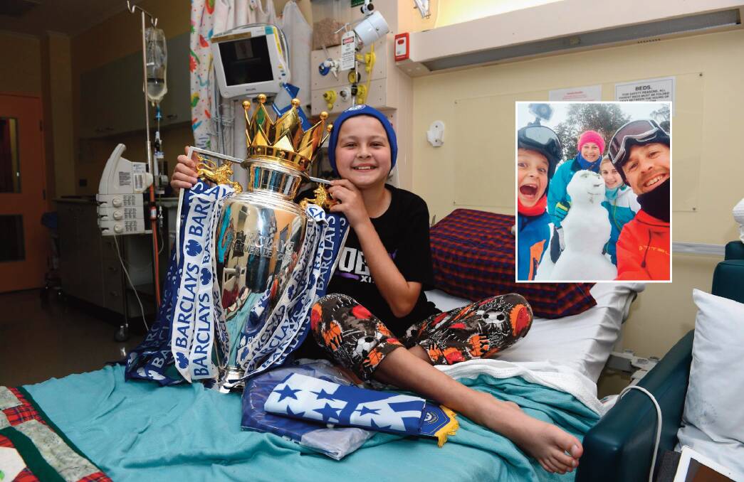 Giving hope: Connor with the English Premier League Trophy that his beloved Chelsea Football Club won in 2015. He was visited by the then captain John Terry and held the cup in Westmead Childrens’ Hospital. Inset: The family on their Make A Wish Foundation skiiing holiday.