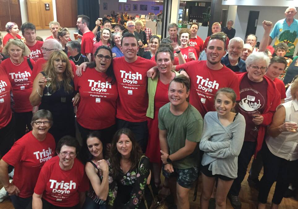 Labor's Trish Doyle celebrates with her family and supporters at Lawson Bowling Club on election night: Ms Doyle was re-elected on Saturday night with a record swing towards her. 