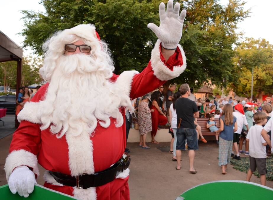 Ho ho ho: Santa drops into town to greet the children and wish everyone a Merry Christmas. He is pictured at a previous Springwood Late Night Christmas Shopping.