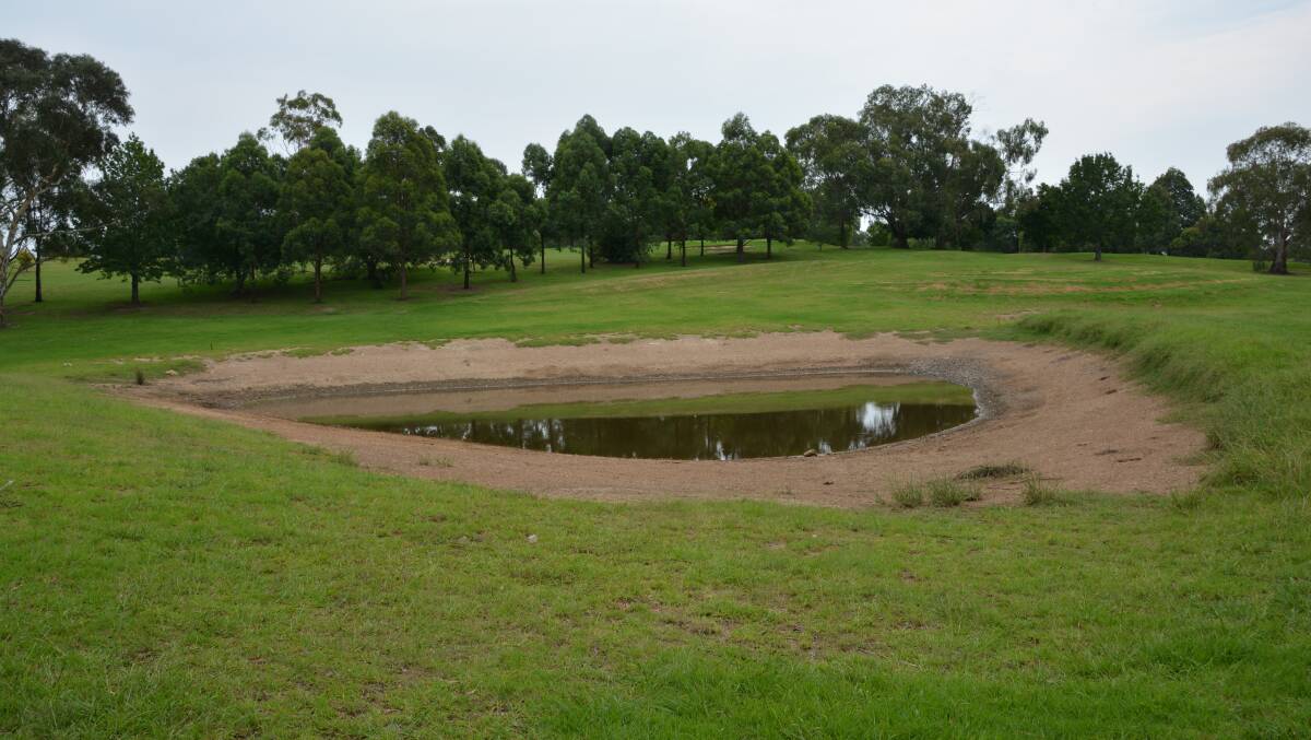 Loss of water: The depleted dam at Springwood Golf Course.