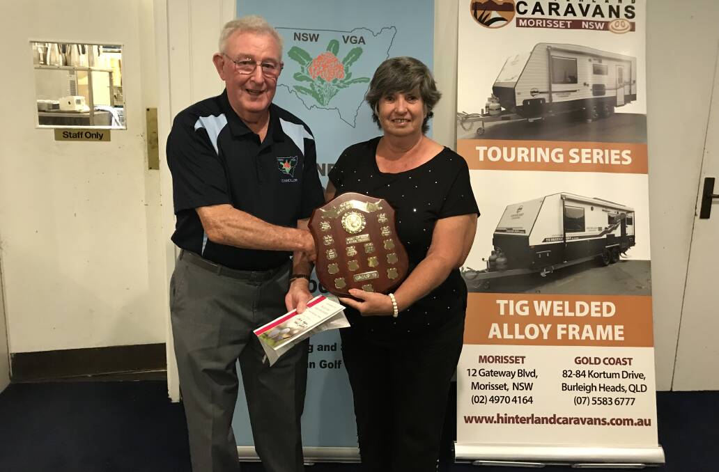 NSWVGA Secretary Len Payne presents this year's prizes and plaque to Bargara GC's Christine Algie. Photo: Richard Ledden-Cooper.