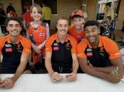 GWS Giants players, from left, Joe Fonti, Ryan Angwin and Callum Brown with young Blue Mountains players Lucille and Felix Craye at Faulconbridge on March 27. Picture supplied