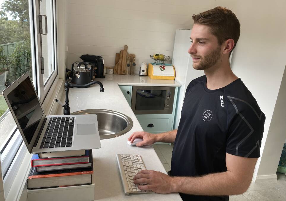 Kieran Fercher works from home, standing up in the kitchen, still ensuring the laptop is at eye height.