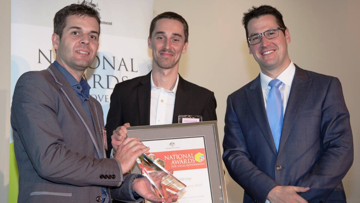 Blue Mountains Cultural Centre director Paul Brinkman and Street Art Murals Australia founder Jarrod Wheatley receive the National Award for Excellence in Local Government for the Katoomba Street Art Walk from Senator Zed Seselja.
