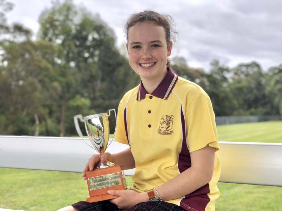 Zoe, 13, holding her gold trophy from the Under 15s 1000m single scull. 