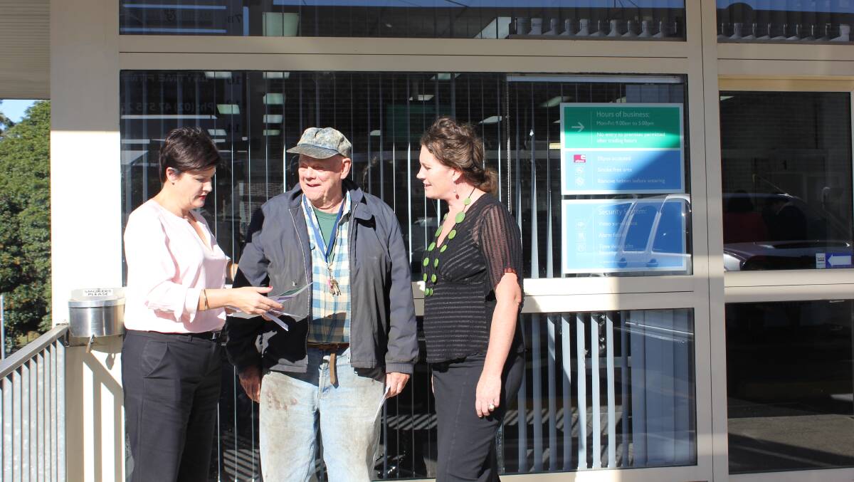Labor's roads spokeswoman Jodi McKay chats with Roland Davey and Blue Mountains MP Trish Doyle outside the motor registry in Springwood.