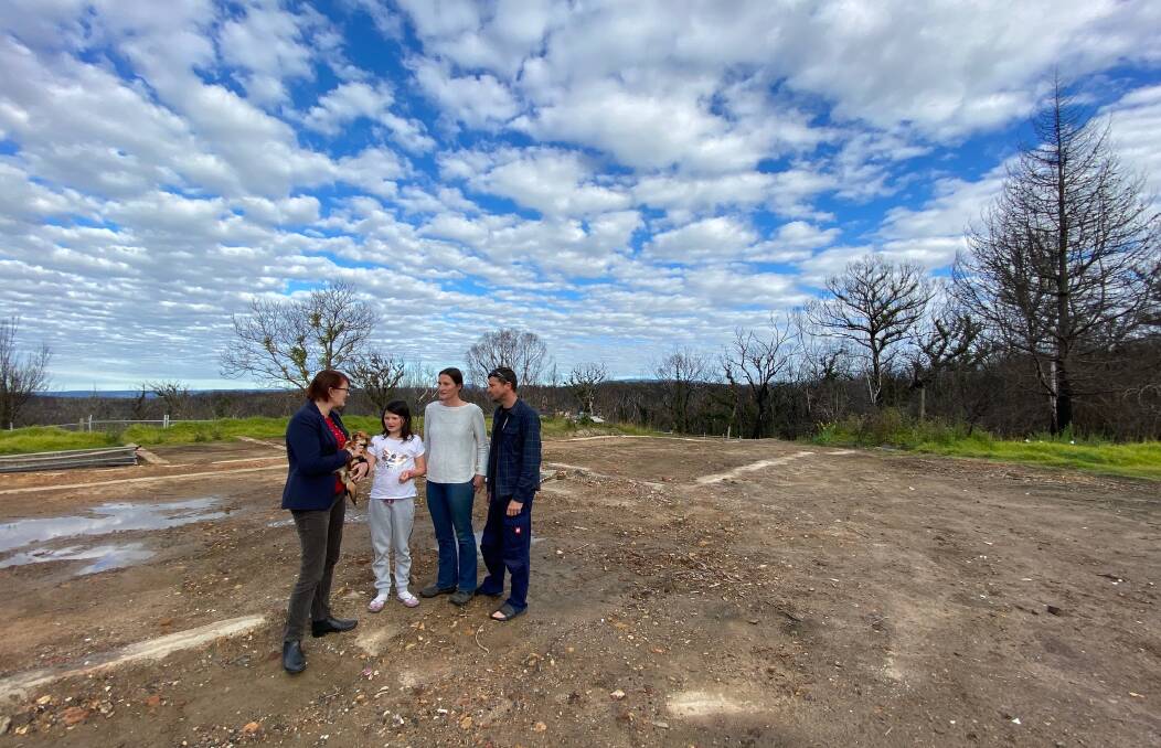 Bushfire survivors: Macquarie MP Susan Templeman holds Raven the dog while speaking with Kiera, Megan and Chris Kezik at the site where their Bilpin home burned down in December.