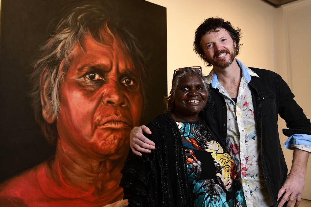 Aboriginal Elder Daisy Tjuparntarri Ward and David Darcy in front of Darcy's portrait which won this year's Archibald People's Choice award. Photo AAP Image/Bianca De Marchi 