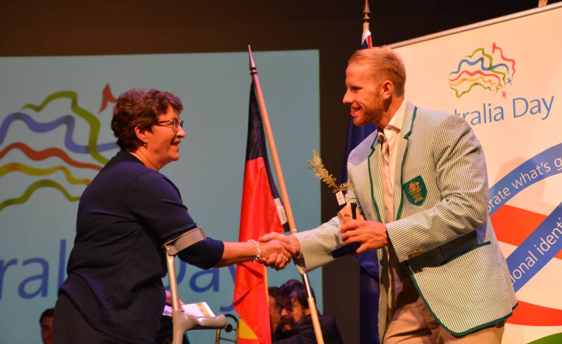 Blue Mountains Citizen of the Year Helen Walker receives her honour from Australia Day Ambassador and Olympian, Cameron Girdlestone.