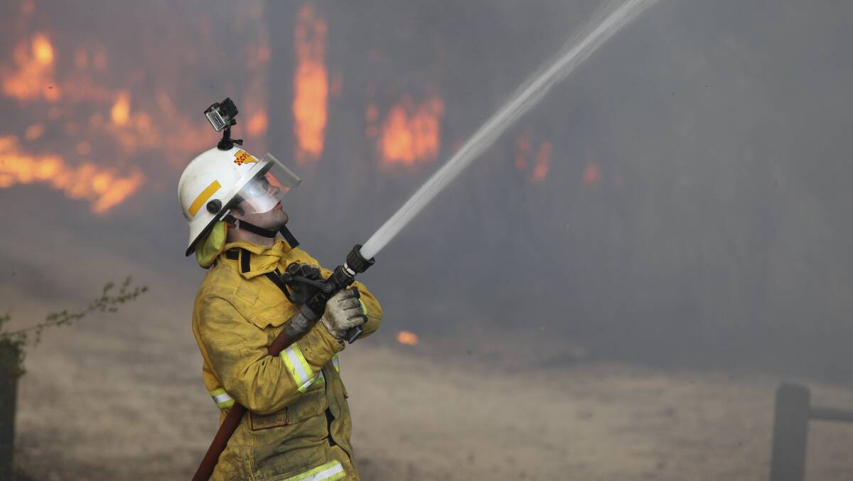 A firefighter tackles the bushfire at Winmalee in October 2013. Photo: Janie Barrett.
