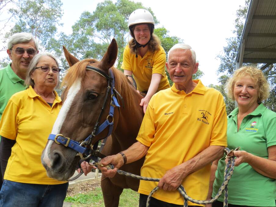 One of last year’s winners, Richard Vandervelden of Blaxland Riding for the Disabled with fellow volunteers, Maxine Kerrison (second left), and Melissa McCann (on one of the organisation’s favoured horses Bernadette). Lower Blue Mountains Rotarians Peter Agar (far left) and Sue Parnell (far right) are also pictured.
