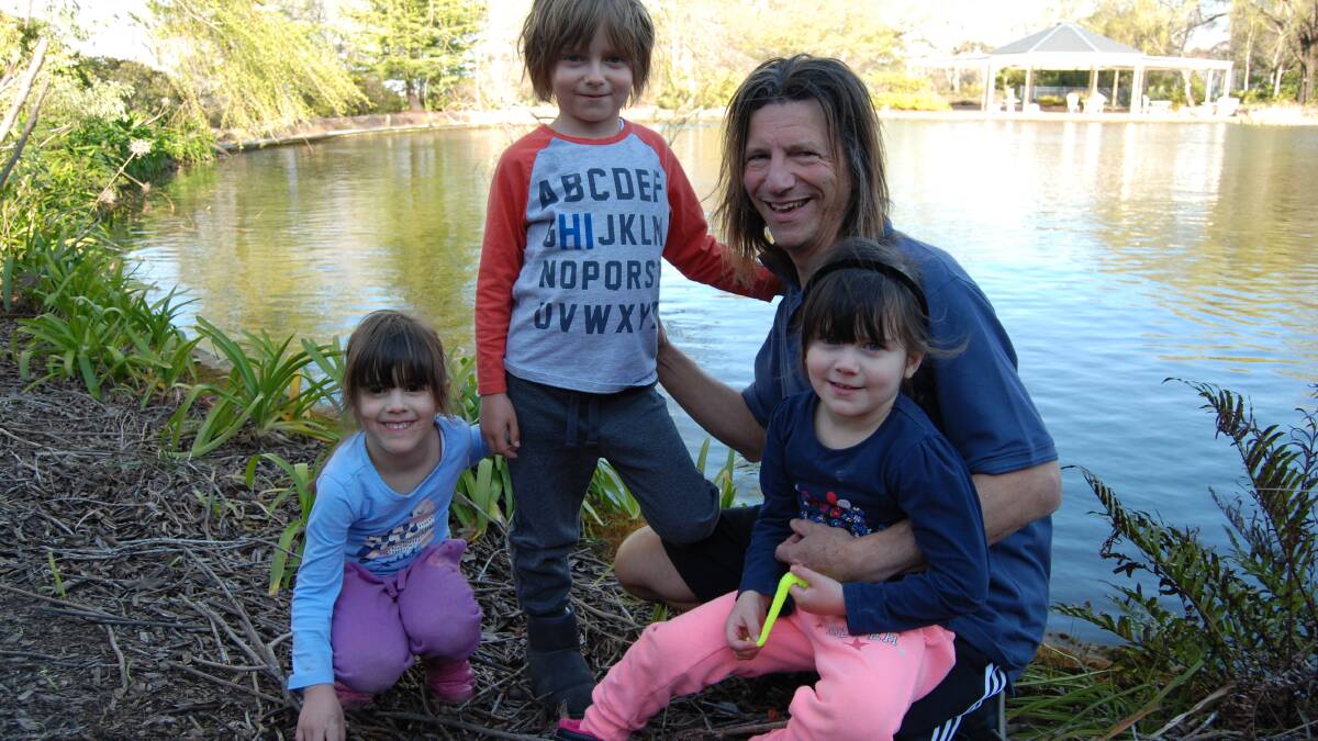 Kids in their kingdom: Hotelier Dr Jerry Schwartz with son Dane, 7, and twin girls Lara and Amber at the pond which will be the site of an ice rink. Pictures B.C Lewis. File photo.