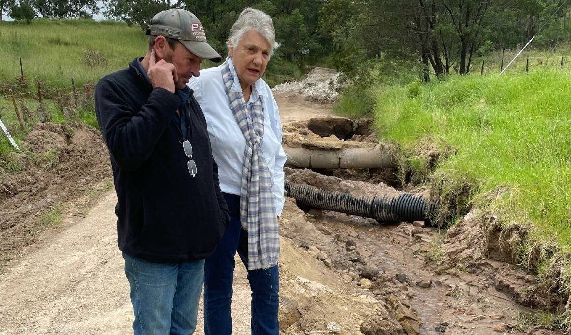 Catherine Harris and neighbour Mark Phillis inspecting the remains of another Valley road - Peach Tree Rd - in May this year. Picture supplied.