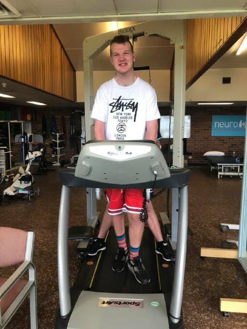 Alex Partington is an "incomplete quadriplegic" continuing to amaze his physiotherapists and selectors at the NSW Gladiators wheelchair rugby team about his commitment to improving his condition. Pictured on a machine he is fundraising to get locally.