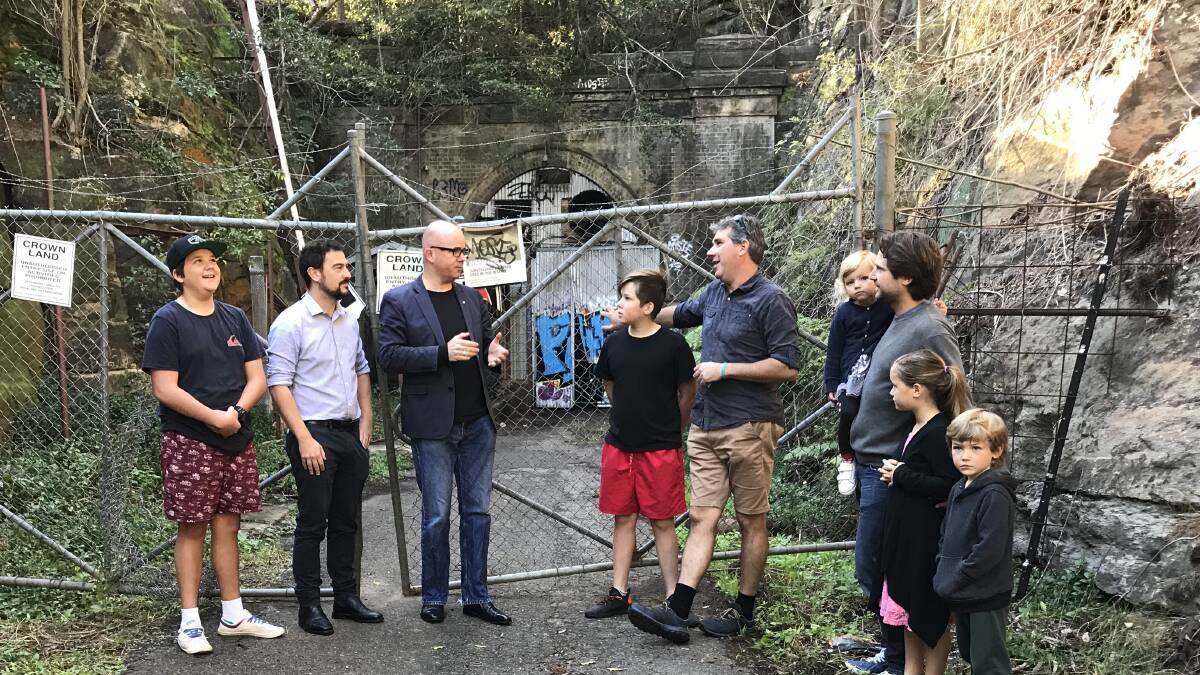 Years of neglect: Council wants to work with the NSW government to reopen the Lapstone Hill Tunnel, for the public. Cr Brendan Christie and Mayor Mark Greenhill with residents campaigning on the matter - David Watson and Adam Podolski and children.