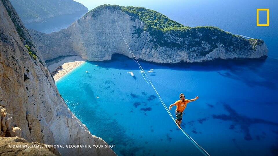 Aidan Williams work in National Geographic. Williams snapped the world record of Swiss-born athlete Samuel Volery at Navagio ‘Shipwreck Beach’ in Zakynthos, Greece – when Volery walked a 570 metre line blindfolded and without falling in 45 minutes. 