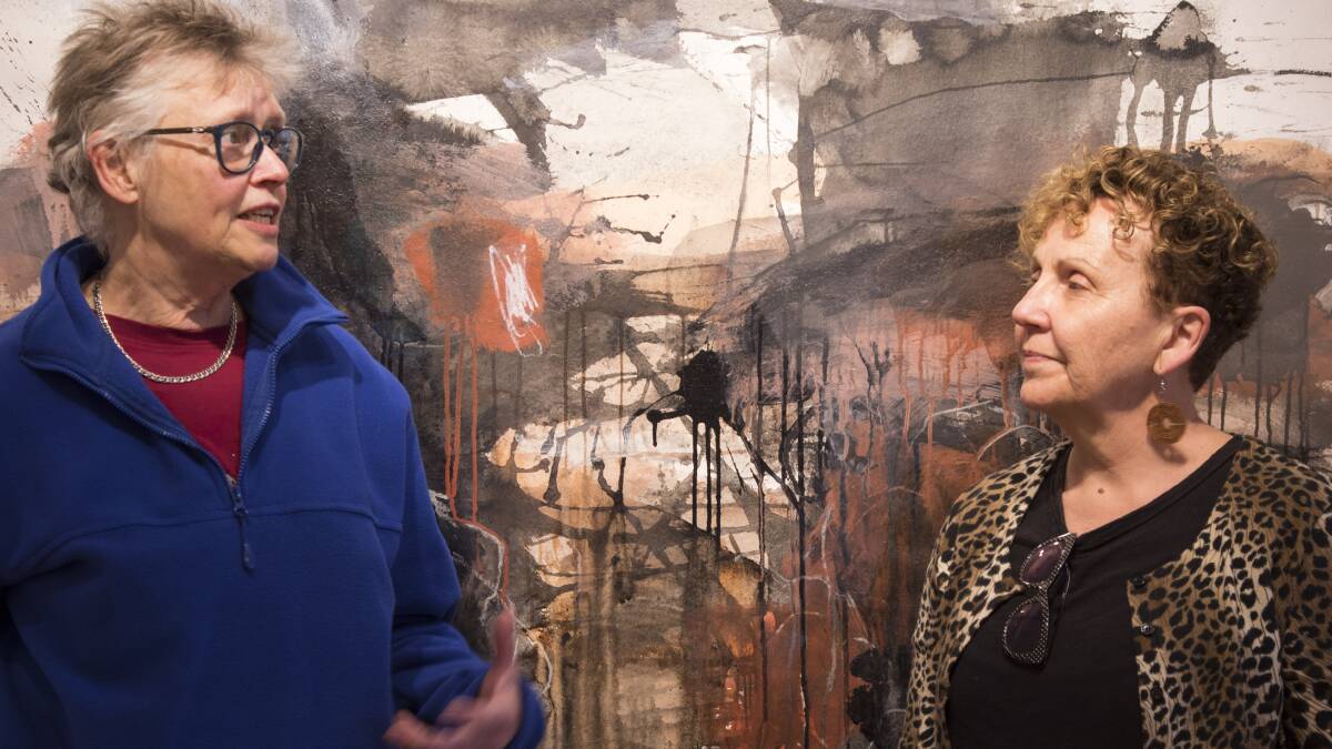 Wentworth Falls artist Ruth le Cheminant (left) and curator of the exhibition, Julie Parkin, in discussion in front of Ruths work for the exhibition.