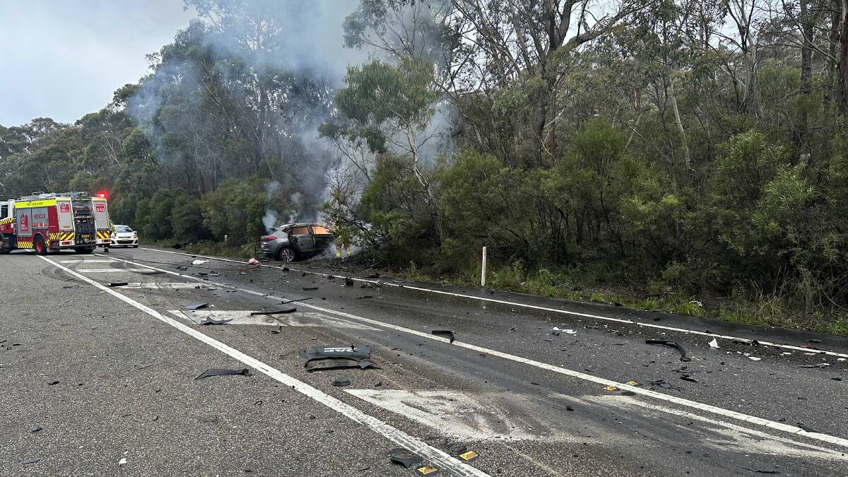 The car on fire on the Great Western Highway at Katoomba. Picture by Michael Paag