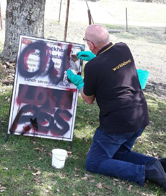 John Rose: Demonstrating how to remove tags from a sign.