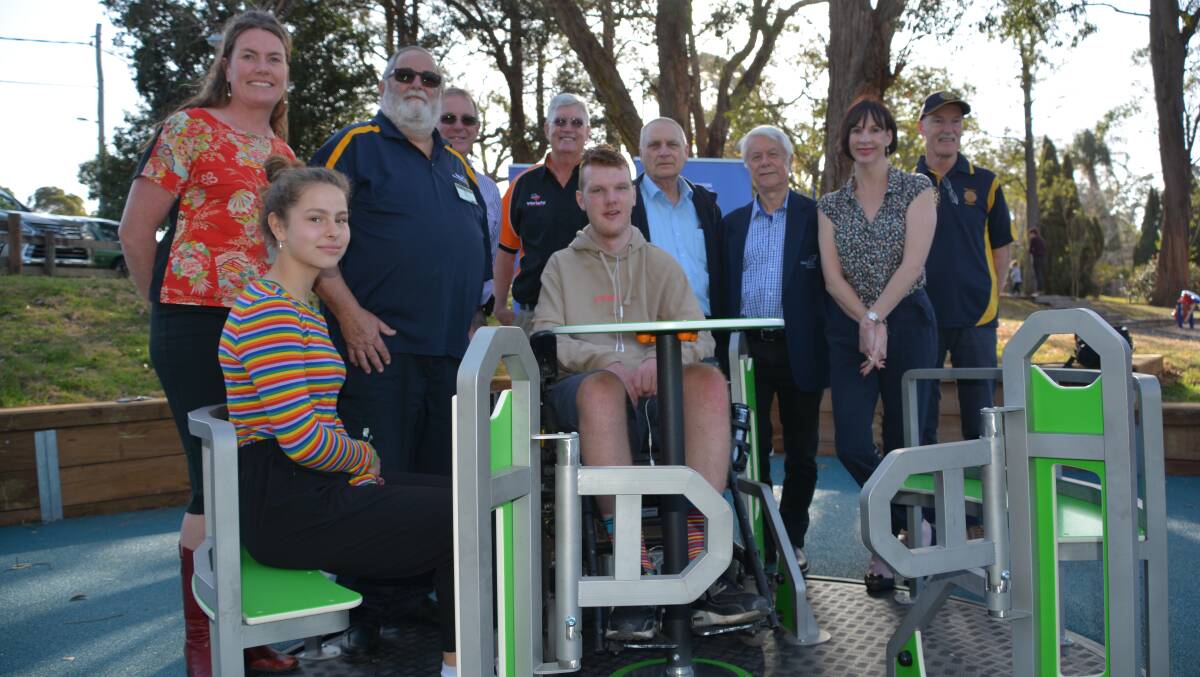 It's here: Rotarians, including Norm Kitto (third from left), with local councillors, Variety representatives, the state MP and Alex Partington (centre) on the carousel.