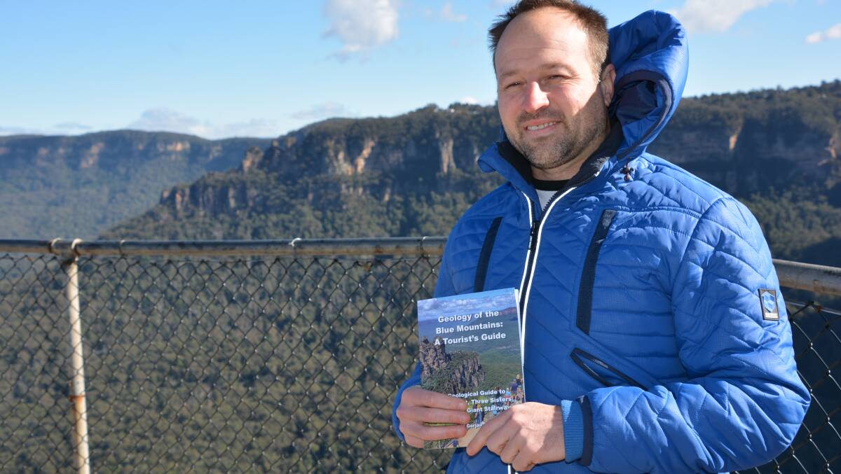 With the Three Sisters in the background: Paul Gorjan with his book Geology of the Blue Mountains: A Tourist's Guide, which sheds light on our vivid evolutionary story.