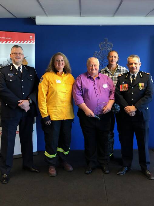 Giving thanks: RFS Mountains chief David Jones with tyre service staff, Heather Helvie, owner Ray Rumble, Bruce Stuart and RFS Deputy Comm. Rob Rogers. 