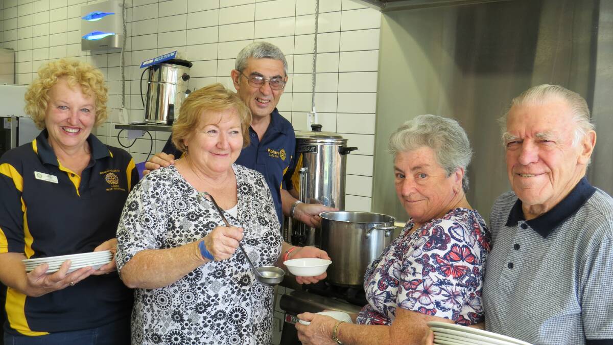 Hard at work: Rotarians Sue Parnell and Peter Agar made a surprise visit to one of last year’s winners, Carol and David Williams (hard at work preparing meals as usual) whilst delivering nomination forms to Springwood Civic Centre last week. From left, Sue Parnell, Carol Williams, Peter Agar, Sandra Henry and David Williams.
