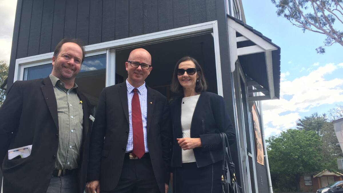 Council representatives: Greens Cr Brent Hoare, Labor Mayor Mark Greenhill and Labor Cr Romola Hollywood inspect one of the proposed tiny homes that could help someone struggling to pay their rental bills.