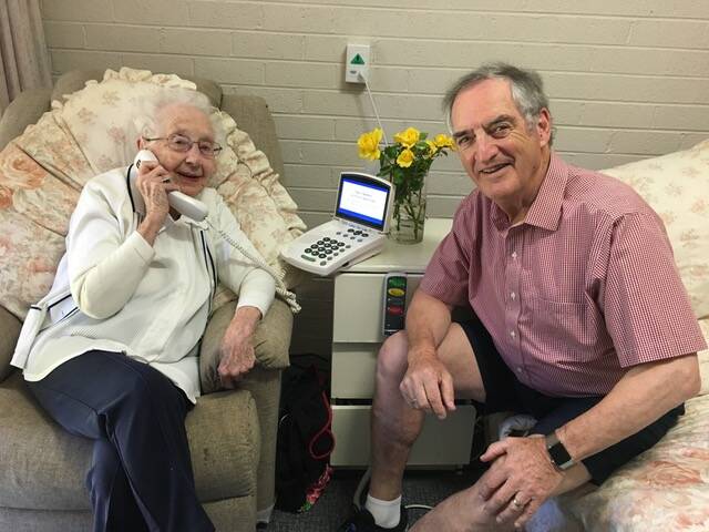 Phone is a lifeline: Betty and Chris Levy. Here on her 103rd birthday at Bucklands Retirement Village in Springwood. Betty is deaf so relies on being able to read the good wishes on her CapTel phone, set to be cancelled early next year. She received an Order of Australia for services to the Red Cross.