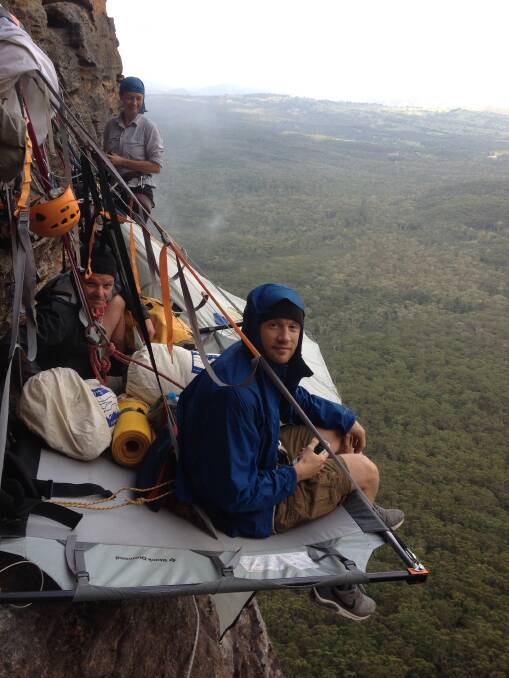 On the edge: Cricketer Andrew "Freddie" Flintoff hangs off a Blue Mountains cliff for Freddie Fries Down Under TV show with sidekick Rob Penn and guide Natasha Sebire. Photo: Marty Doolan